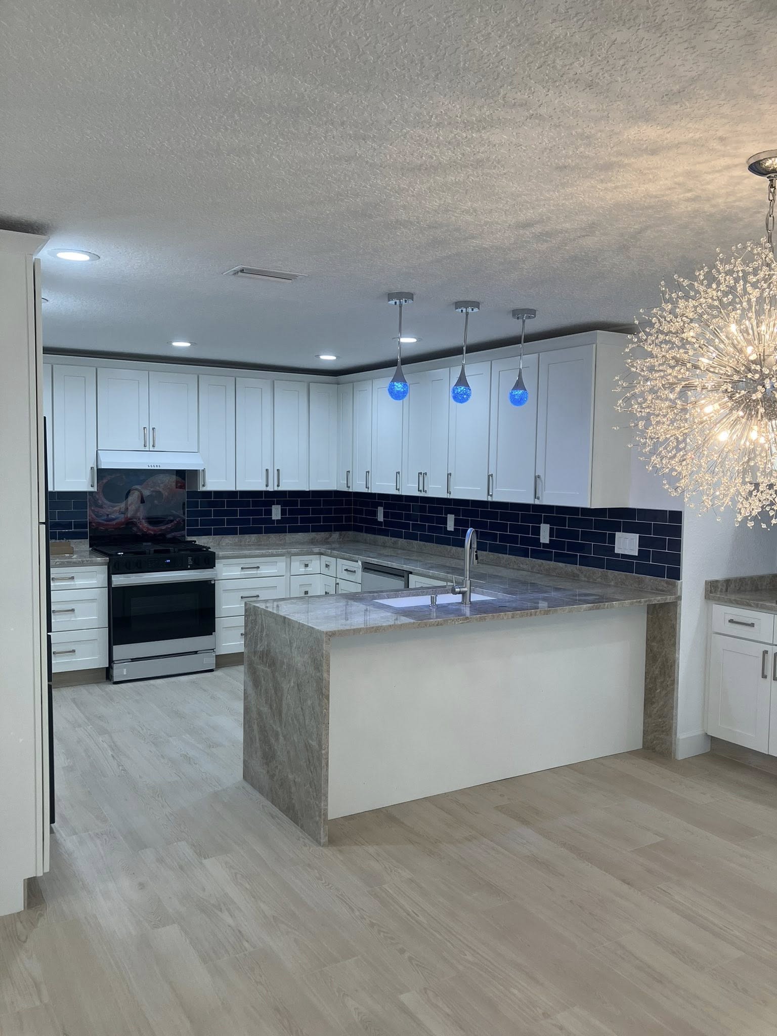 Kitchen remodel with navy tile backsplash